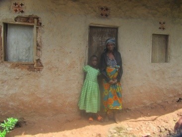woman and daughter standing outside their house