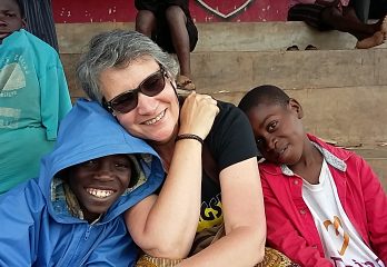 Aid woker with street children in Uganda